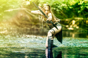 A sexy cosplay girl plays a Diablo 2 inspired female bow hunter